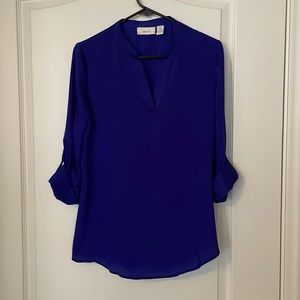 Purple blouse with rolled up sleeves with a button